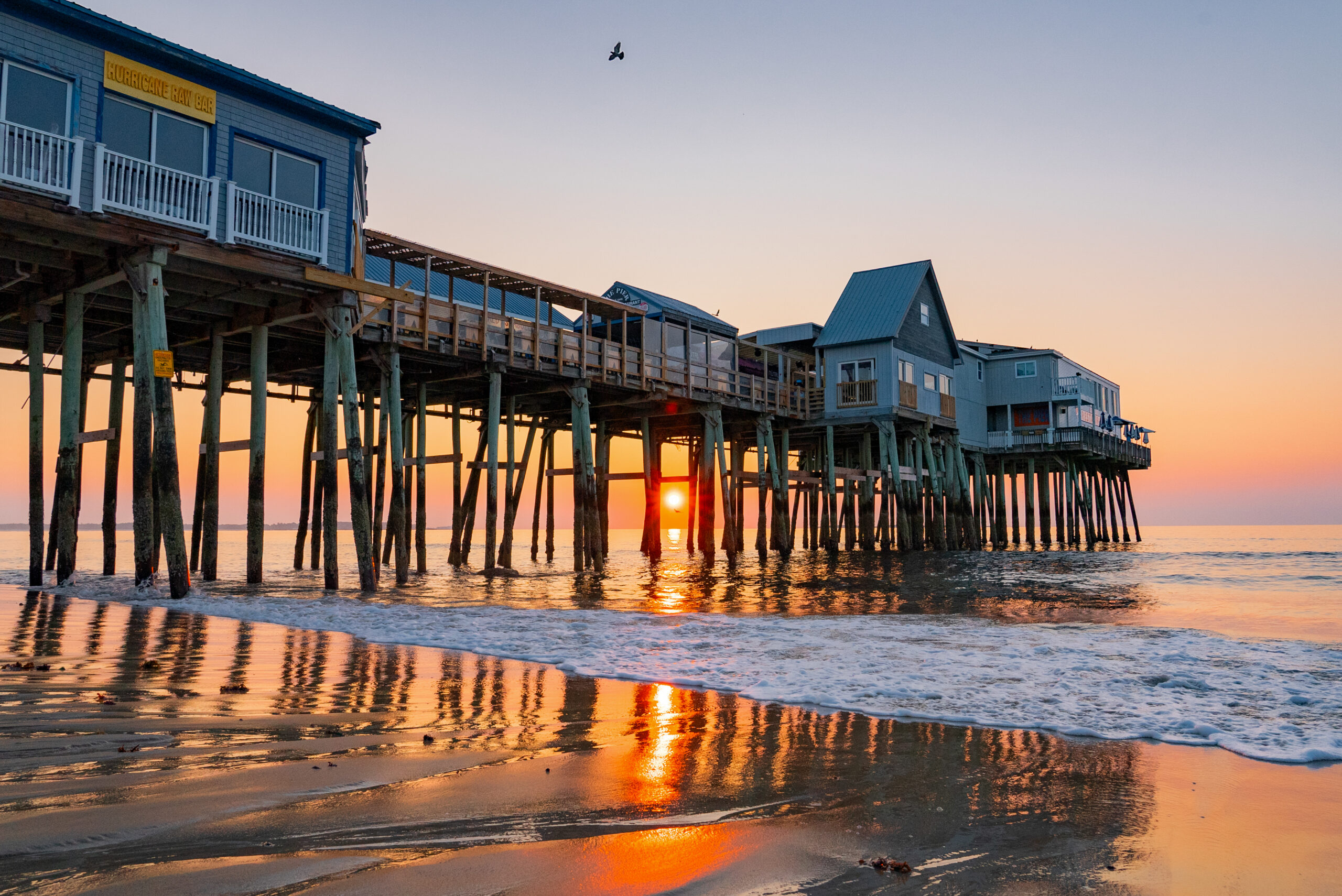 sunrise behind the pier in old orchard